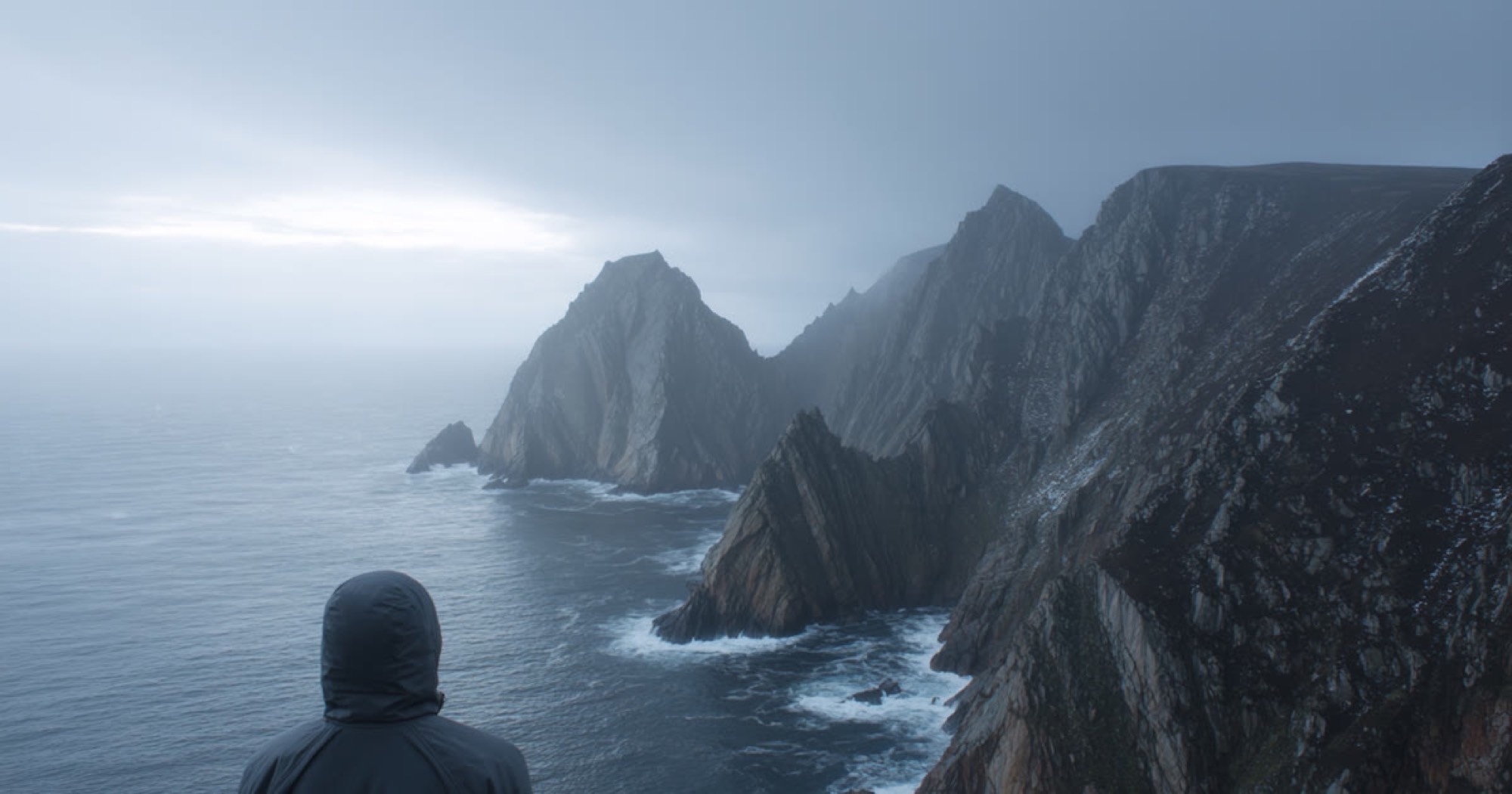 Coastal cliffs, figure looking out over the sea